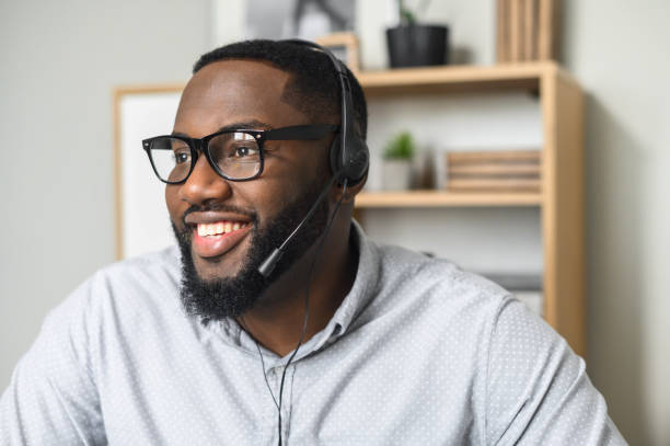 Man with glasses and earpiece smiling and happy that he is on the Agent Opportunity Pathway
