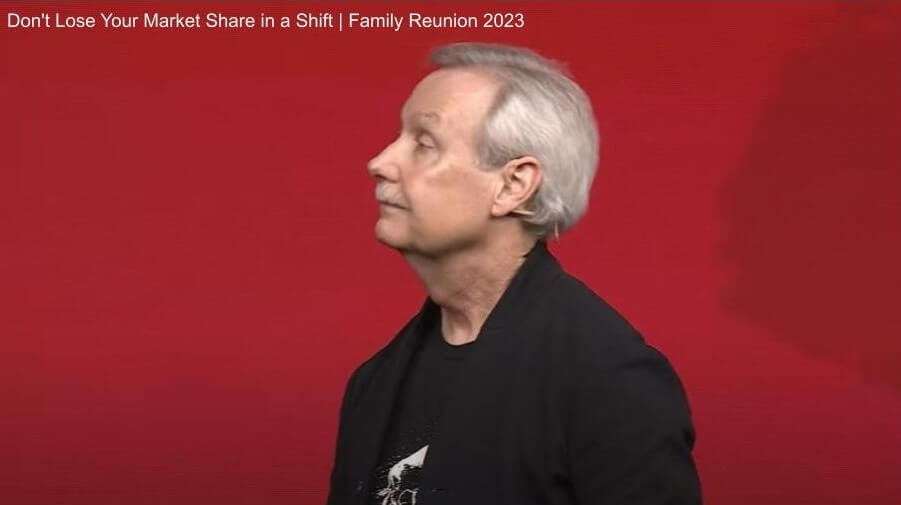 Gary Keller speaking onstage at Family Reunion 2023, telling agents to not lose your market share during a shift, that winners accelerate in turns.